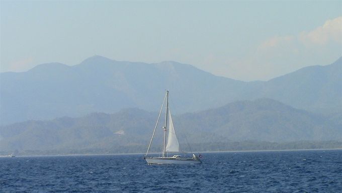 Sailing with moody mountains in the background