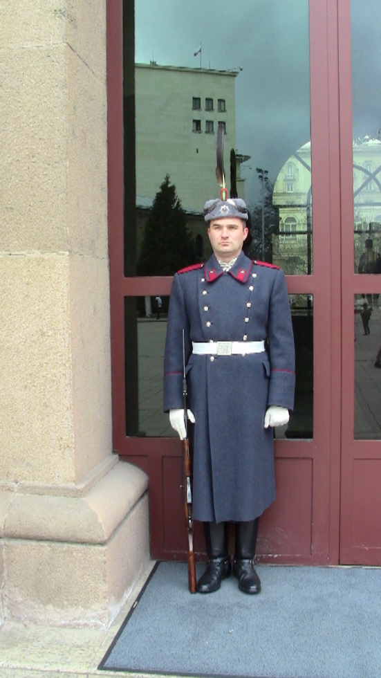 Guard at Presidency building. Note feather in the hat.