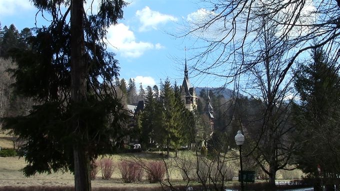 A first glimpse of Peles castle through the forest.